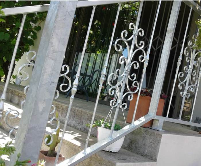 Galvanised steel balustrade with decorative scroll panels