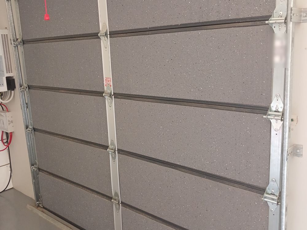 Inside of a sectional garage door showing the foam insulation filling each panel